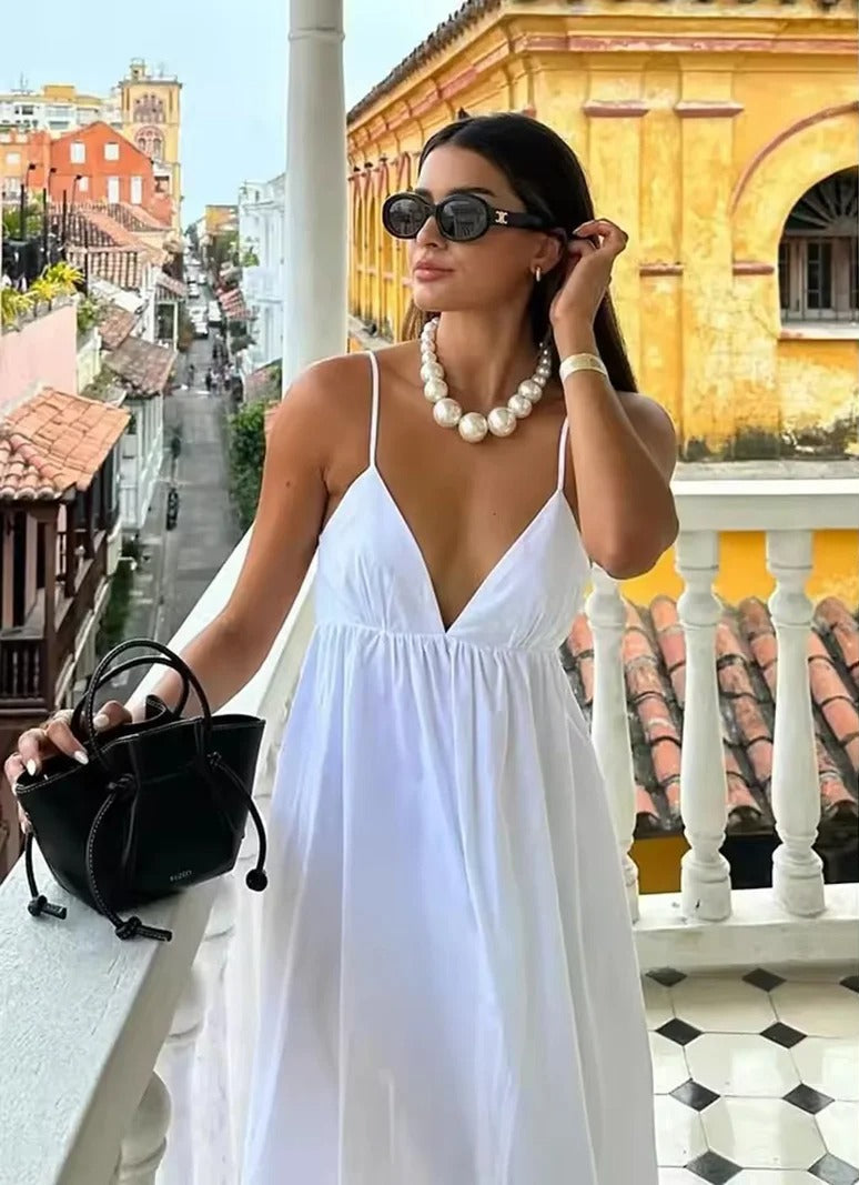 Women's backless spaghetti strap maxi summer dress in flowy fabric, perfect for casual beach vacation.