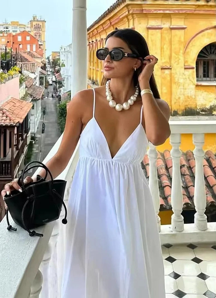 Women's backless spaghetti strap maxi summer dress in flowy fabric, perfect for casual beach vacation.