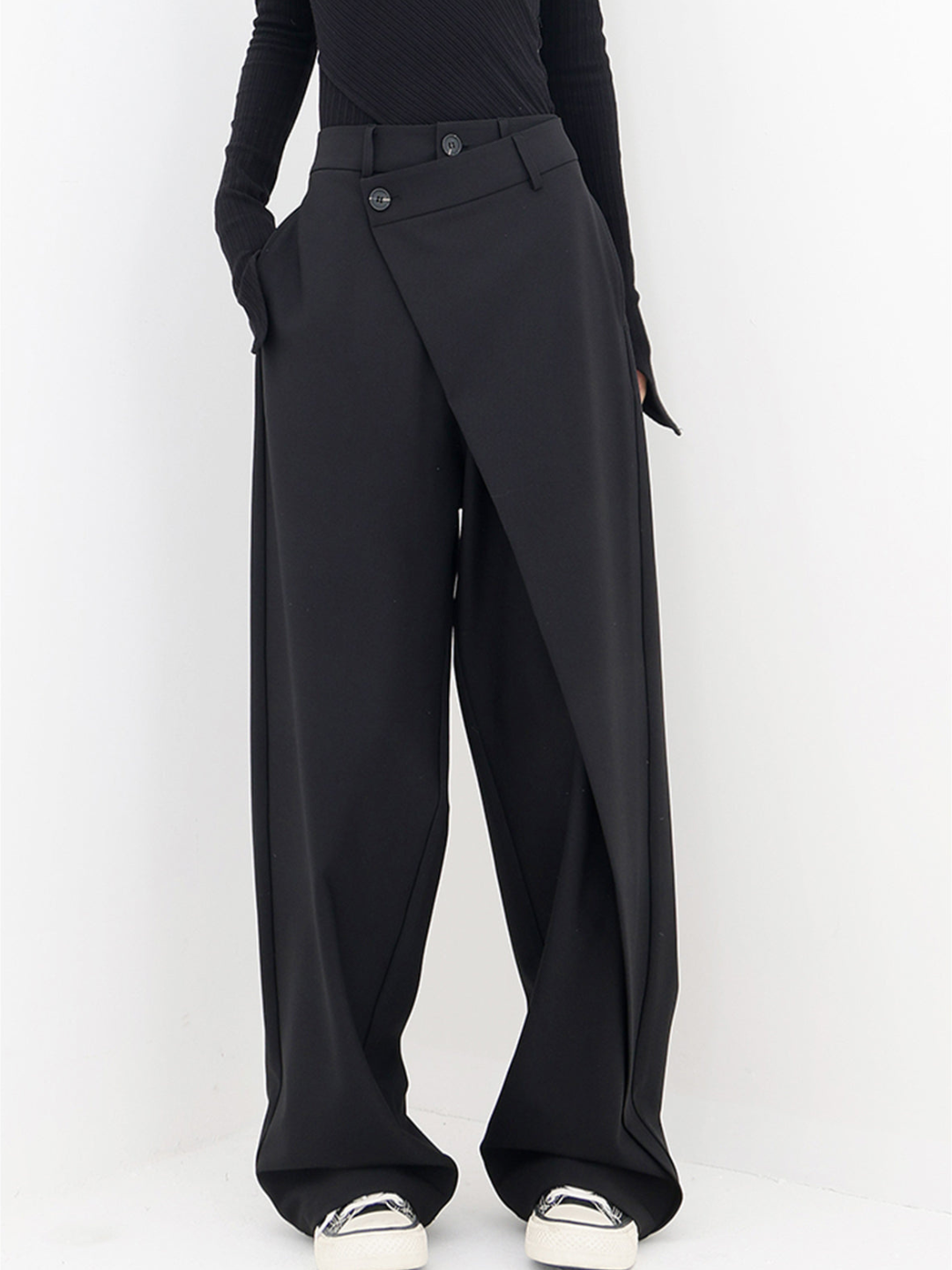 Women's baggy trousers with unique asymmetric waist, relaxed fit, and wide leg for a modern casual look.