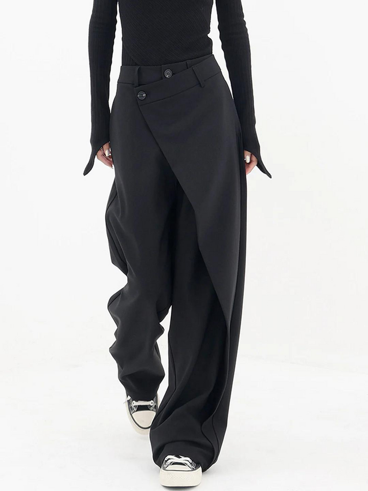 Close-up of trendy women's baggy trousers featuring a distinctive asymmetric waist and comfortable relaxed fit.