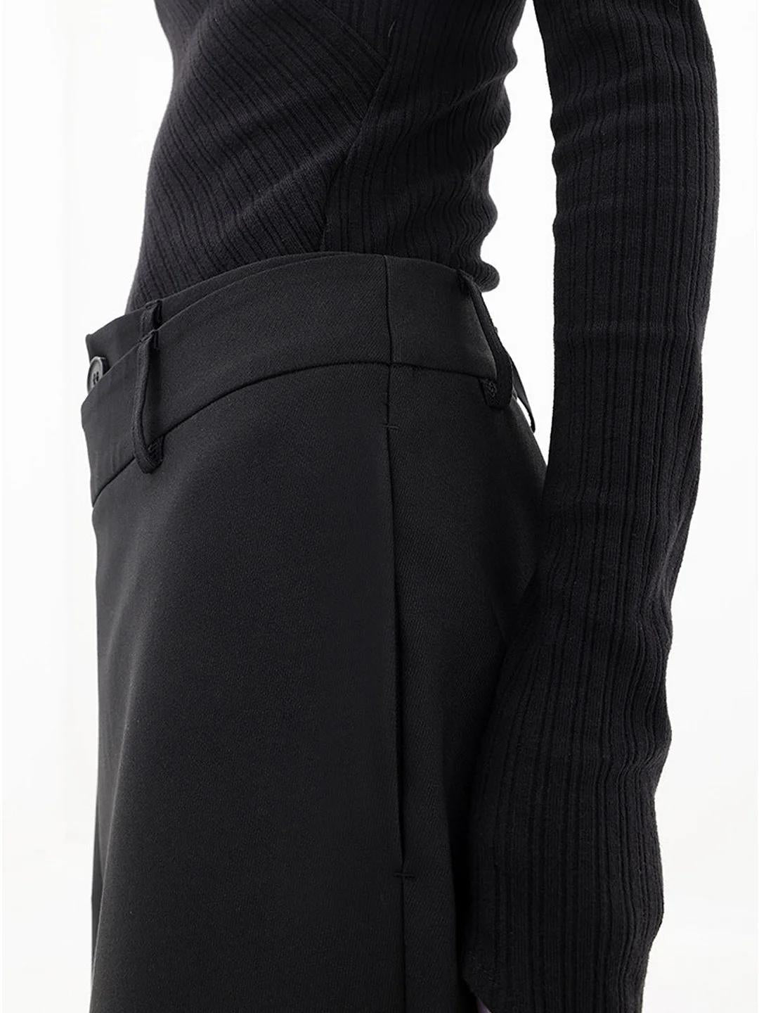 Side view of modern women's baggy trousers, showcasing the relaxed wide leg, comfortable fit, and asymmetric waist.