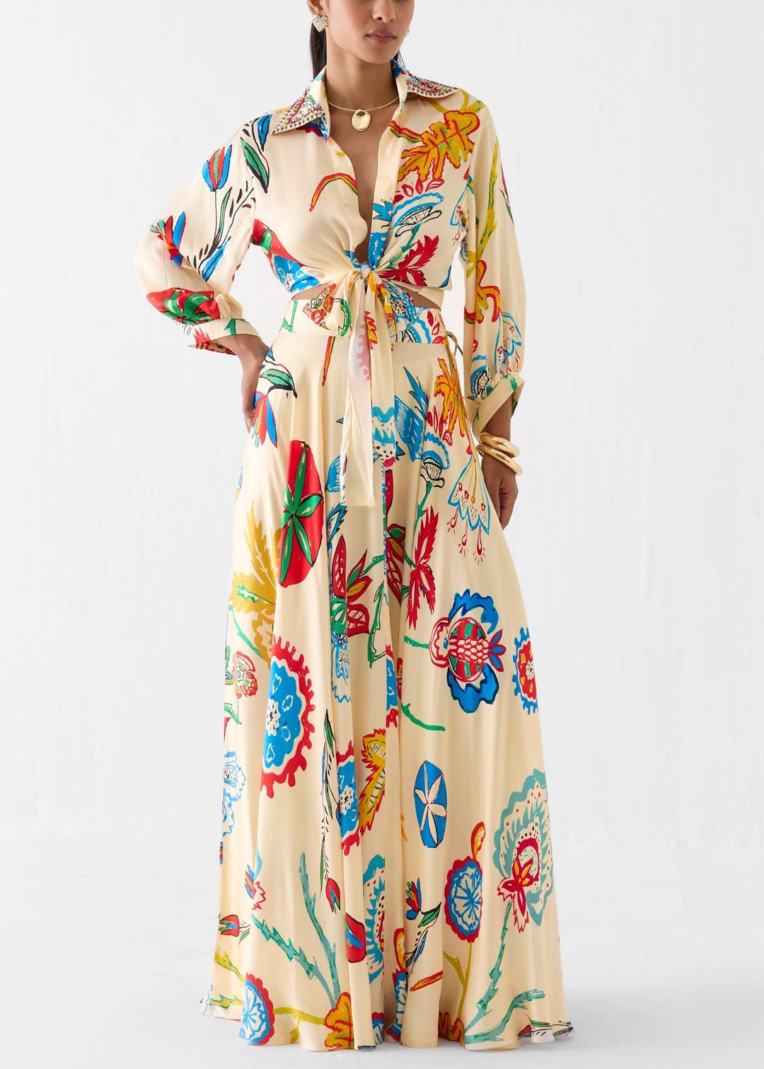 Women's beige floral print tie-front long sleeve shirt & high-waisted maxi skirt matching set.