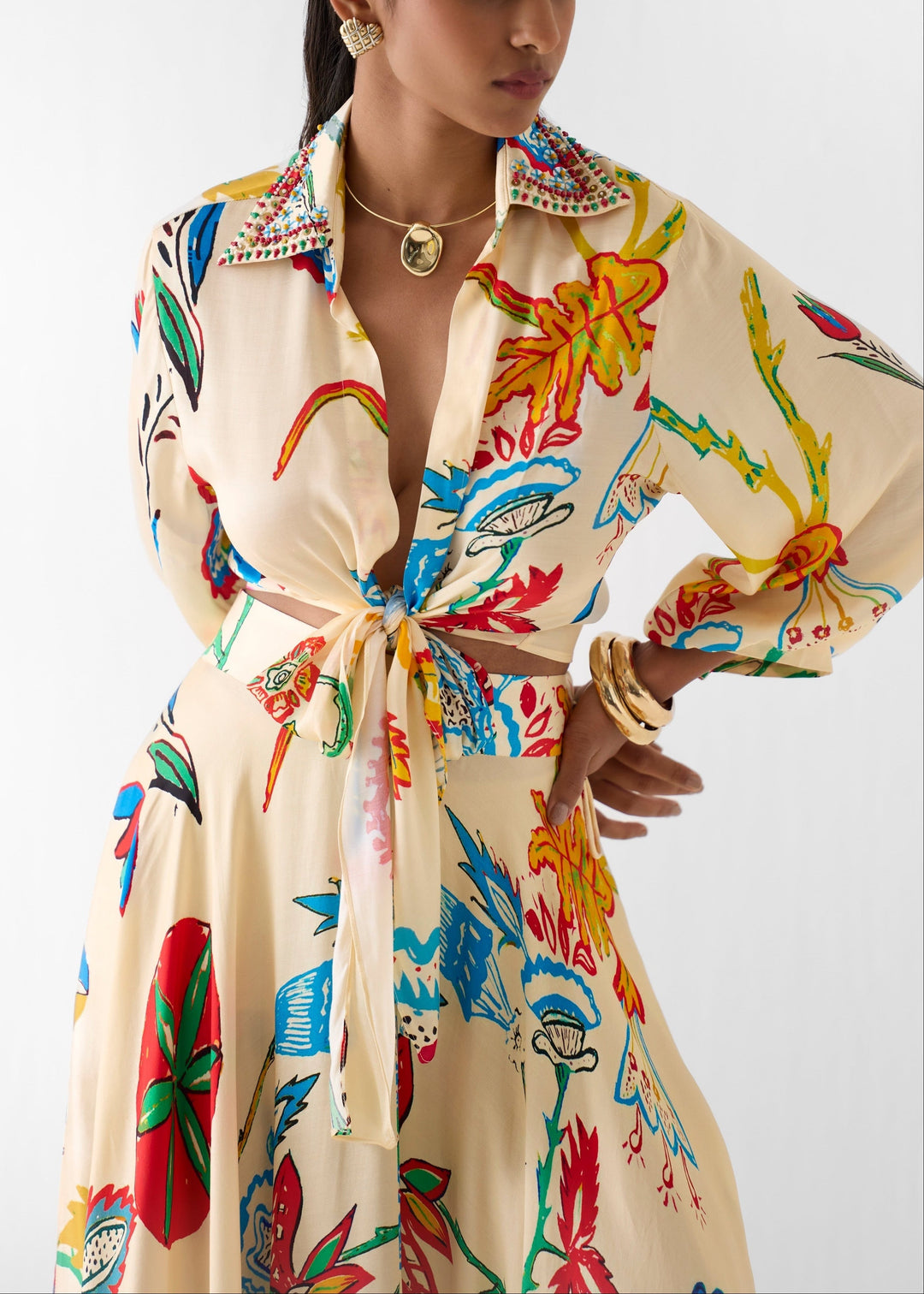 Stylish women's summer fashion floral print tie-front shirt and high-waisted maxi skirt set.