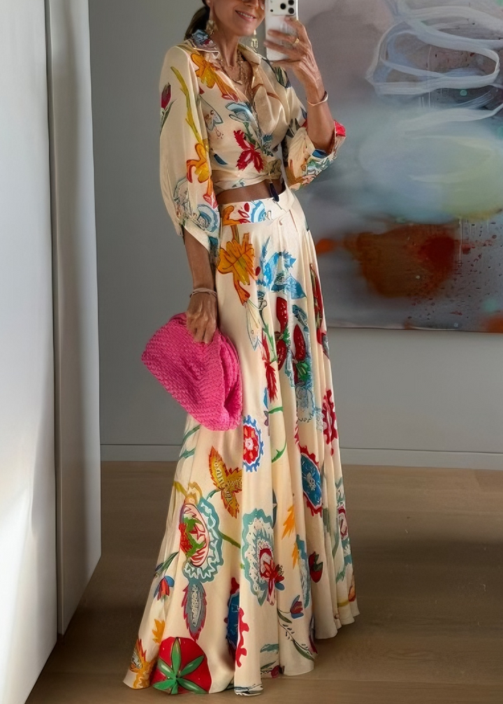 Women's beige floral two-piece set: long sleeve tie-front shirt & high-waist maxi skirt, ideal vacation outfit.