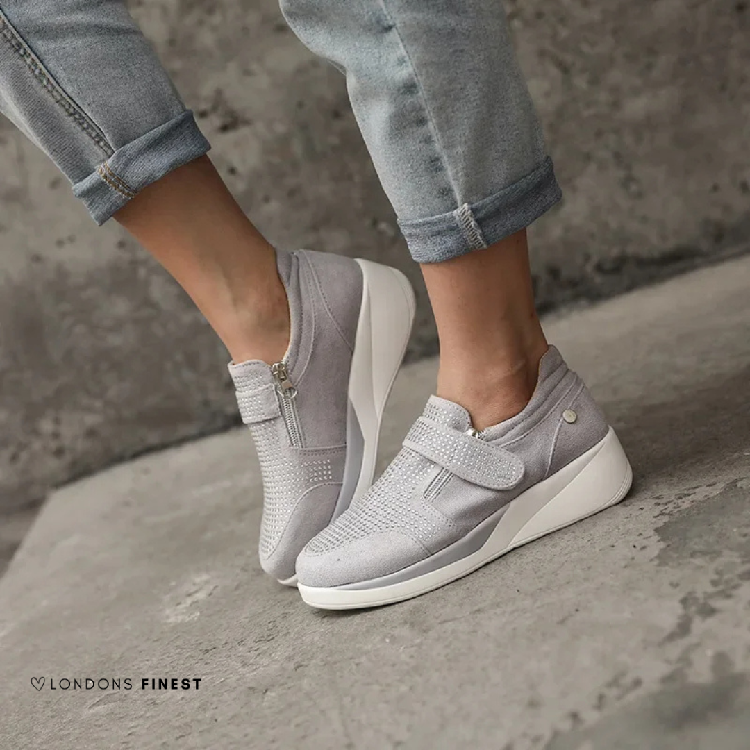 Supportive women's walking shoes in grey, blue, or black, offering arch & posture support for pain relief & comfort.