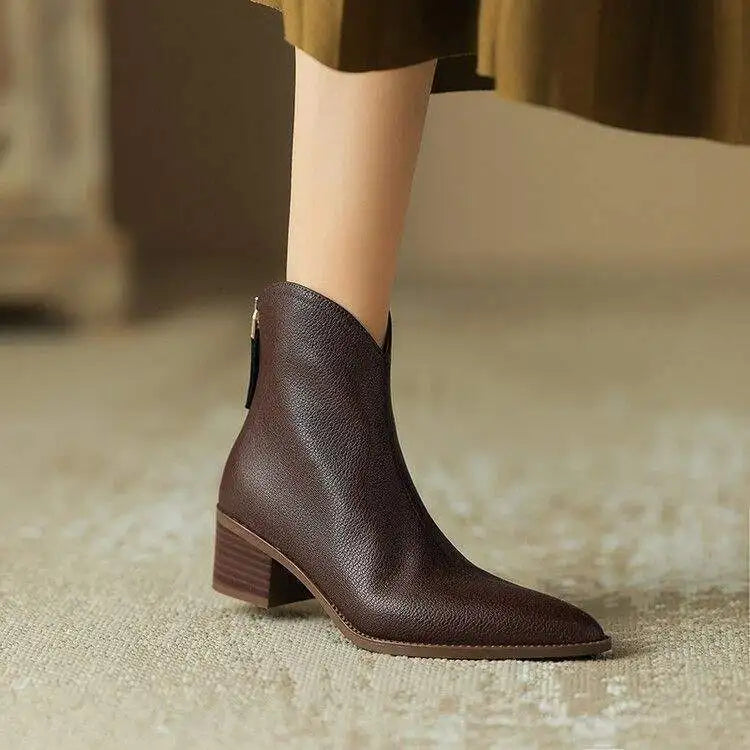 Women's black ankle boots with pointed toe & low heel for stylish everyday wear.