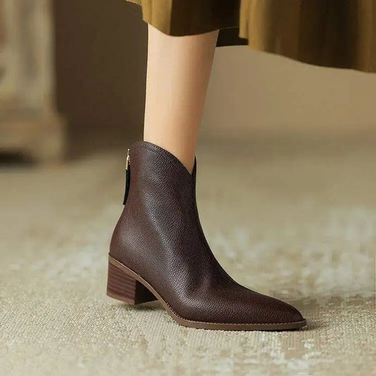 Women's black ankle boots with pointed toe & low heel for stylish everyday wear.