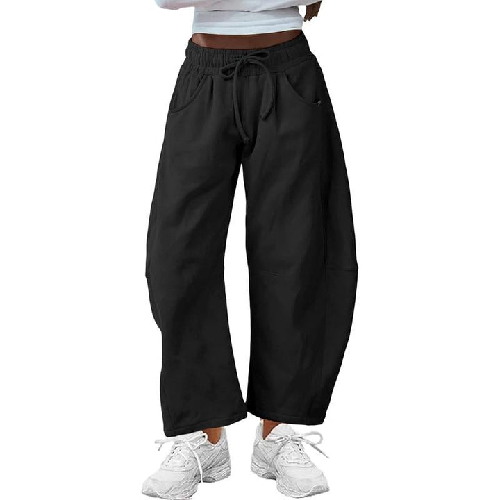 Women's black barrel-leg pants, relaxed fit & comfy drawstring waist for effortless modern style.