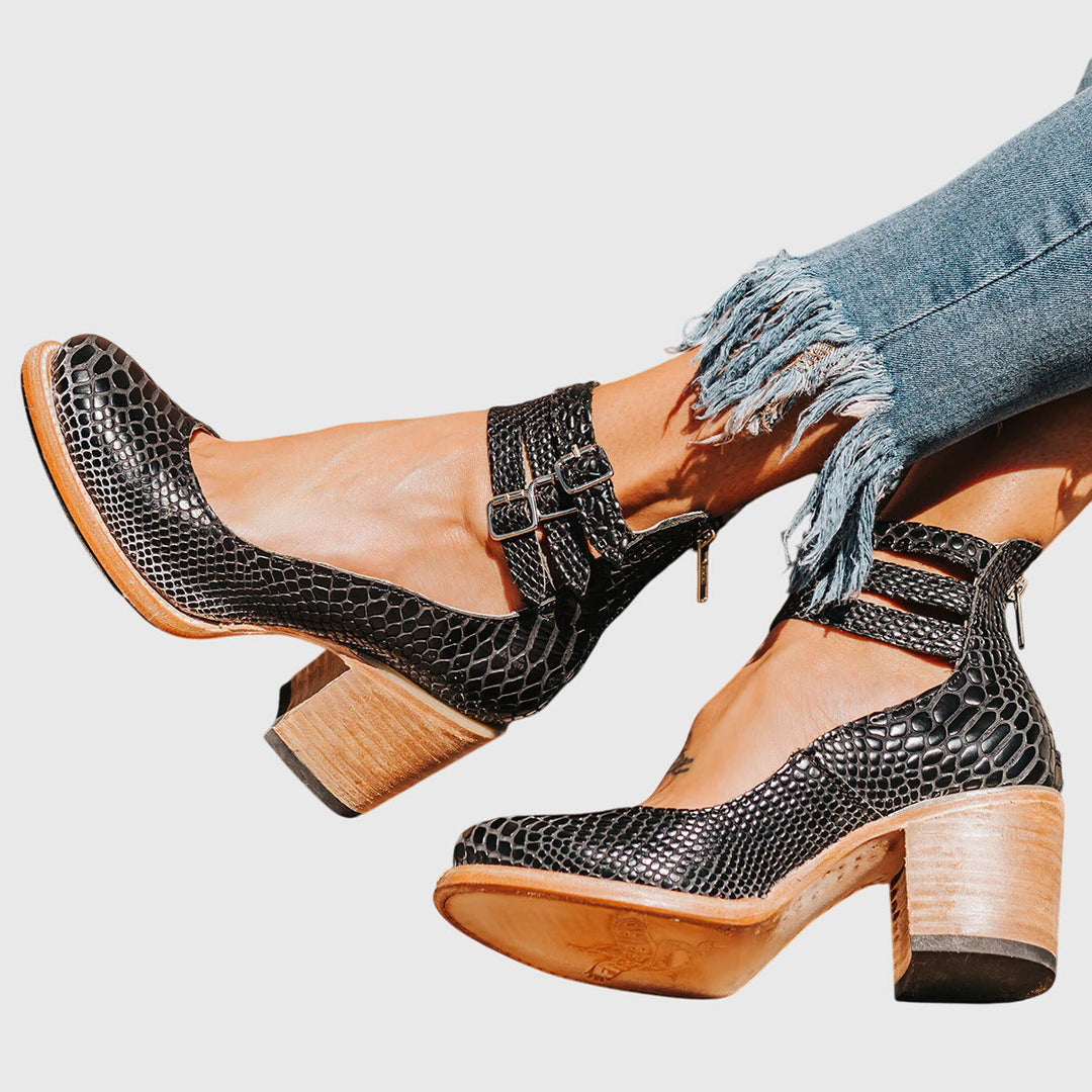 Women's black buckle strap ankle boots with a comfortable block heel, perfect for everyday style.
