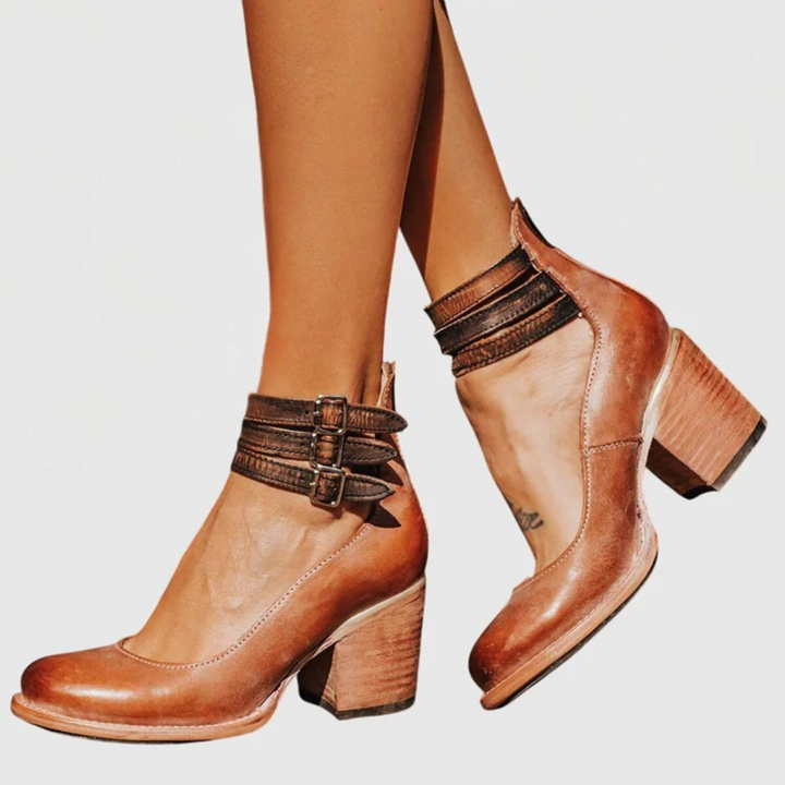 Western-style women's buckle boots with unique cutout detailing and a sturdy block heel for fall.