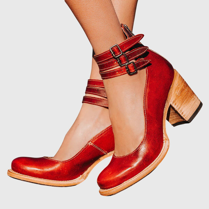 Fashionable fall/winter women's ankle boots with decorative buckle straps, cutouts, and a stable block heel.