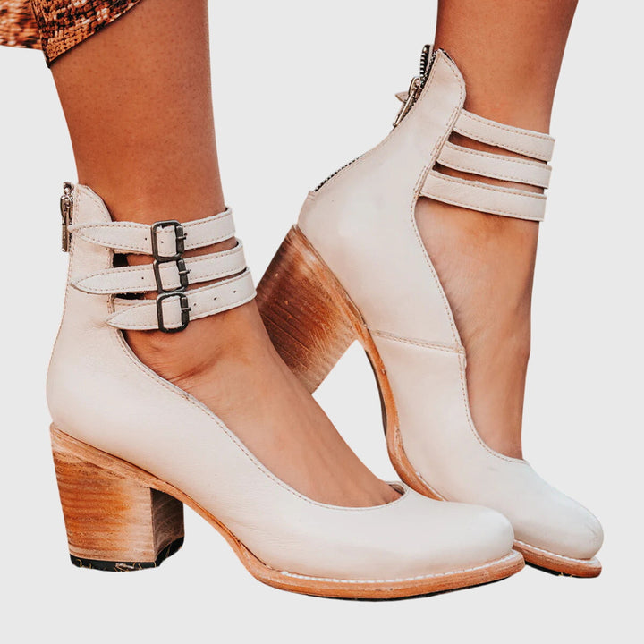Casual women's ankle boots with a comfortable block heel, stylish buckle details, and cutout sides.