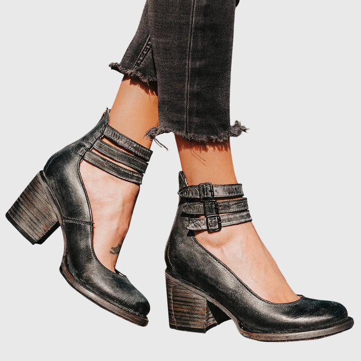 Trendy women's ankle boots with stylish buckle straps, cutout elements, and a comfortable block heel.