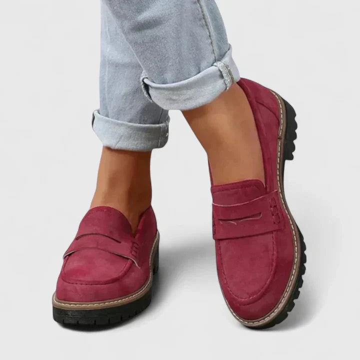 Women's versatile black chunky lug-sole penny loafers. Stylish slip-on platform shoes for modern fashion footwear.