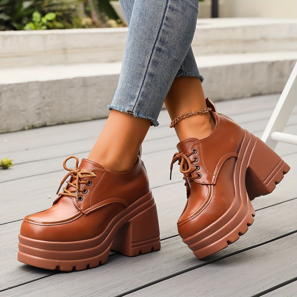 Women's black chunky platform oxfords with a secure lace-up design, offering retro style and comfort.