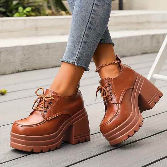Women's black chunky platform oxfords with a secure lace-up design, offering retro style and comfort.