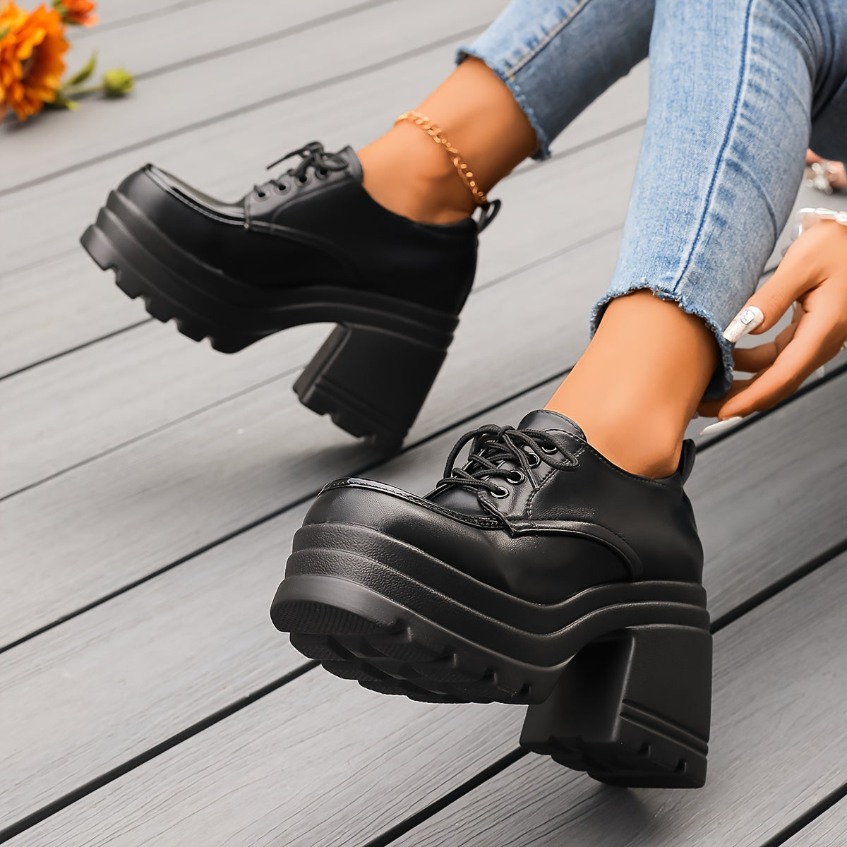 Side profile of women's black chunky platform oxfords, highlighting the elevated sole and block heel.