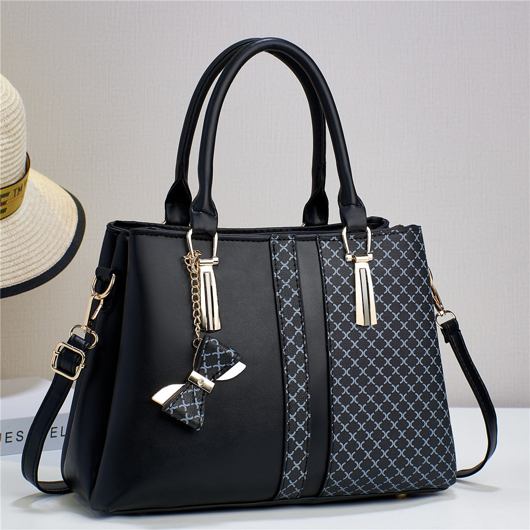 Rear view of the women's black convertible handbag, featuring a convenient exterior zip pocket.