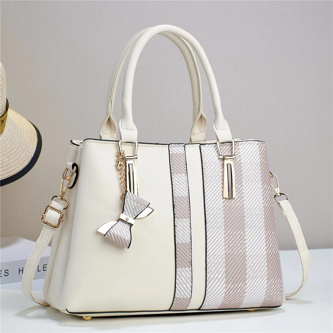 Sleek side profile of the women's versatile black convertible shoulder bag, compact yet spacious.