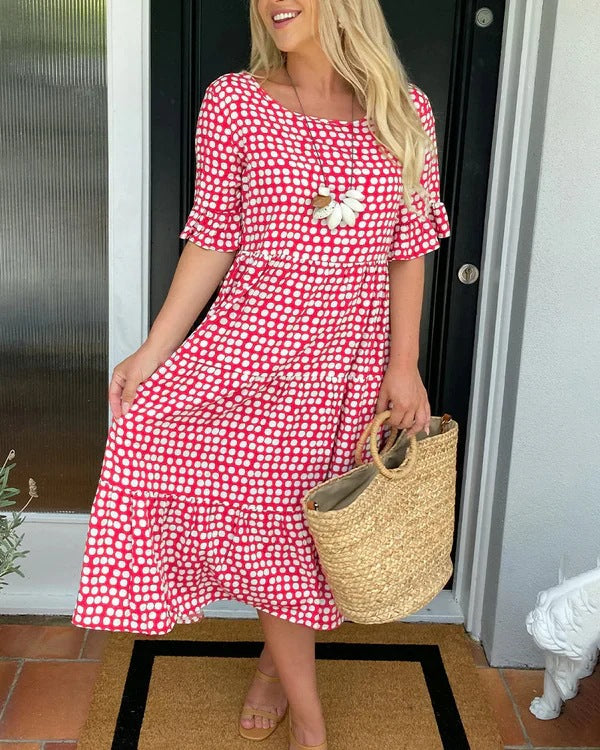 Women's black dotted midi dress with a relaxed fit, perfect for casual summer wear. Flowy and comfortable.
