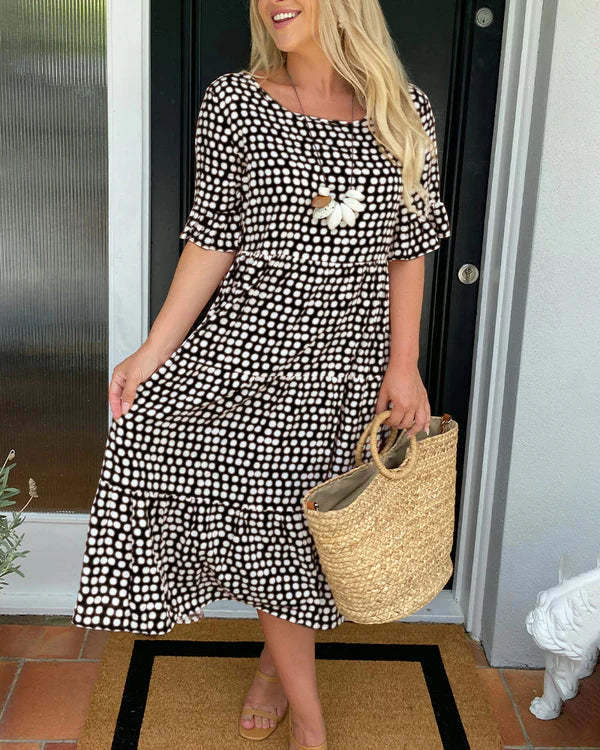 Comfortable flowy women's tiered midi dress with a chic dotted print, great for spring fashion & vacation.