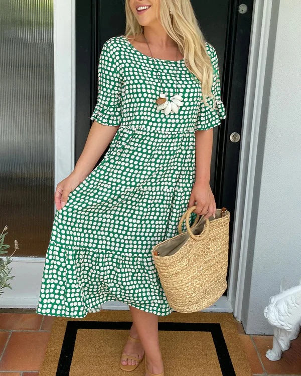 Relaxed fit women's midi dress featuring a classic dotted print, suitable for casual outings or spring wear.