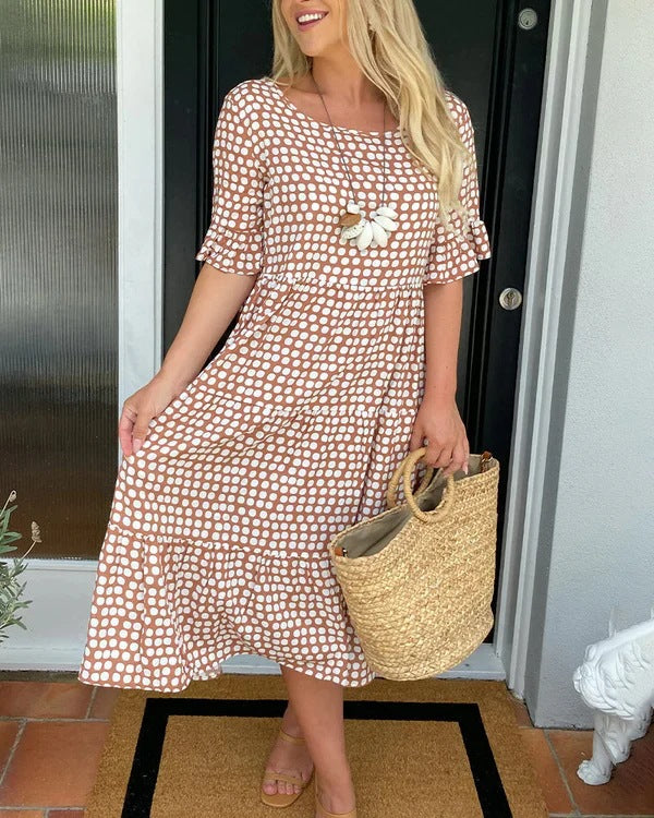 Classic women's dotted midi dress offering a comfortable, relaxed fit. Ideal for spring, summer, or everyday style.