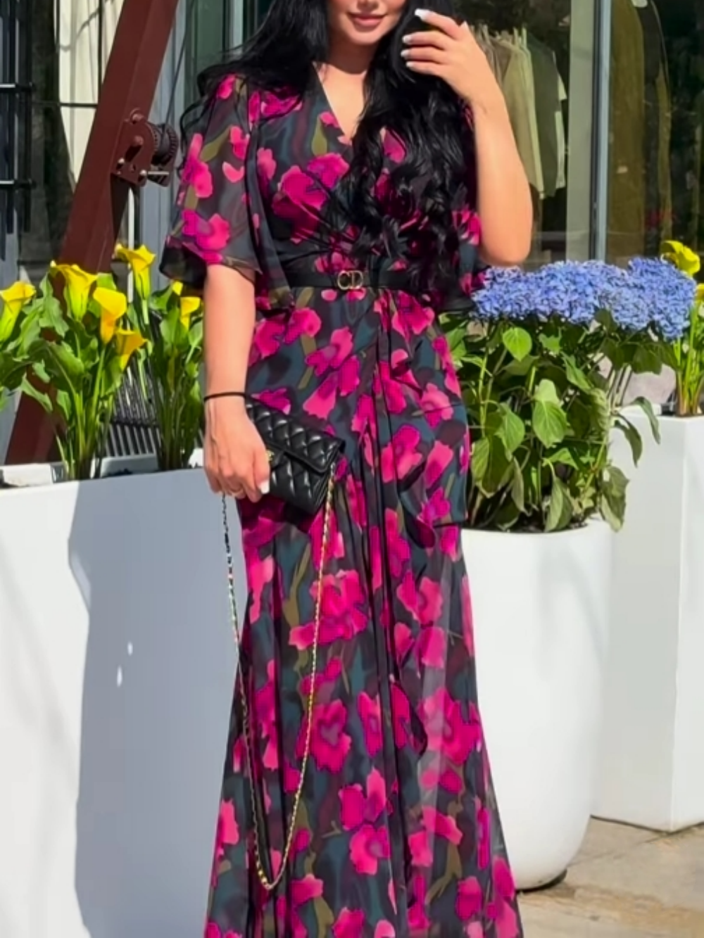 Women's black floral print maxi dress with V-neck and elegant trumpet sleeves for summer.