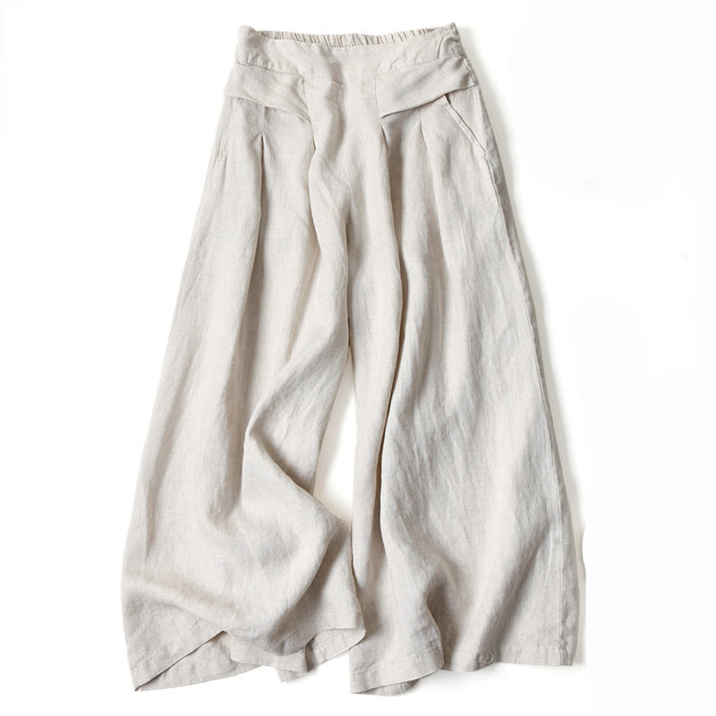 Soft pink women's flowy wide-leg trousers, high-waisted, providing a comfortable and relaxed fit.