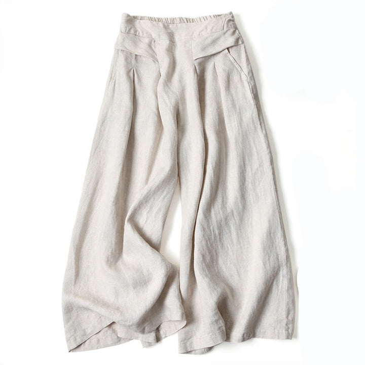 Soft pink women's flowy wide-leg trousers, high-waisted, providing a comfortable and relaxed fit.
