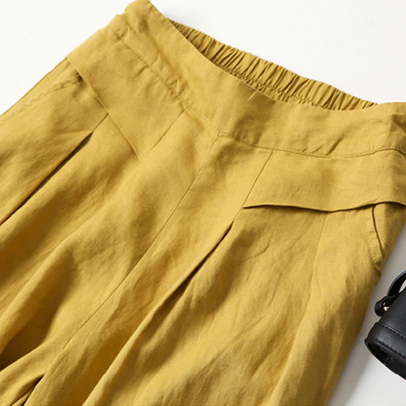 Comfortable women's flowy wide-leg trousers in beige, featuring a high waist and relaxed fit.