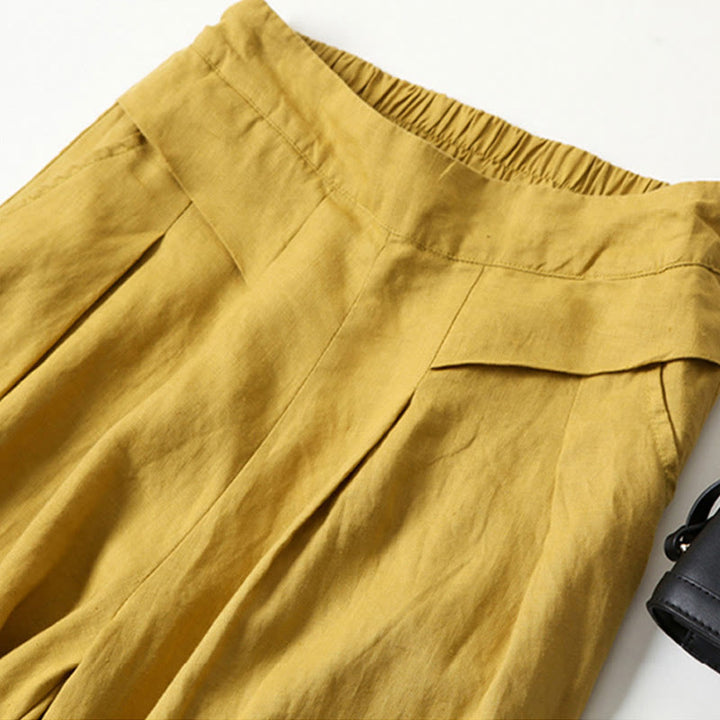 Comfortable women's flowy wide-leg trousers in beige, featuring a high waist and relaxed fit.
