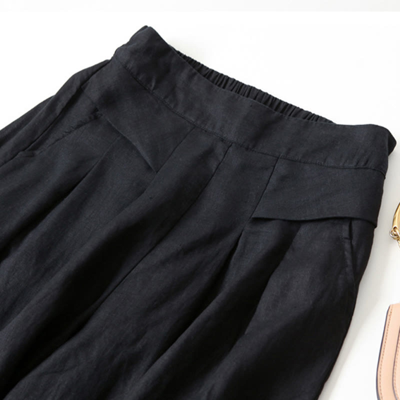 Close-up of soft fabric on women's flowy wide-leg trousers, high-waisted, emphasizing comfort.