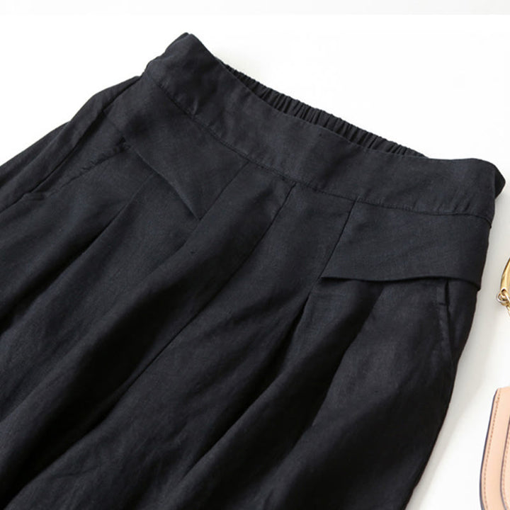 Close-up of soft fabric on women's flowy wide-leg trousers, high-waisted, emphasizing comfort.