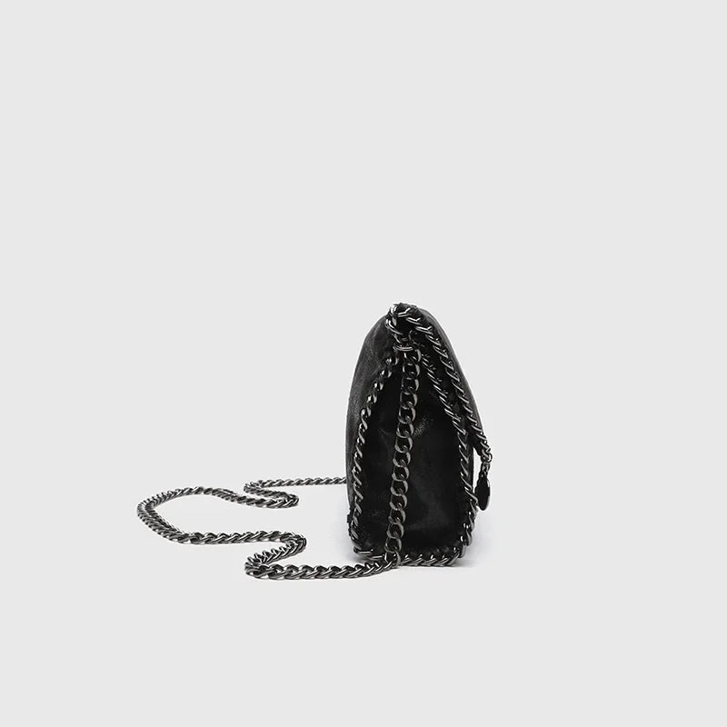 Stylish women's gothic shoulder bag with a bold chain strap, perfect for adding a dark touch to any outfit.
