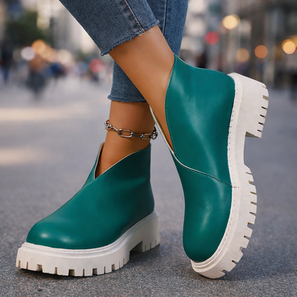 Women's black leather platform slip-on shoes for casual comfort and style.
