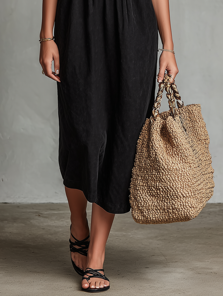 Bohemian black midi dress for women, featuring intricate floral embroidery, a flattering square neck, and sleeveless style.