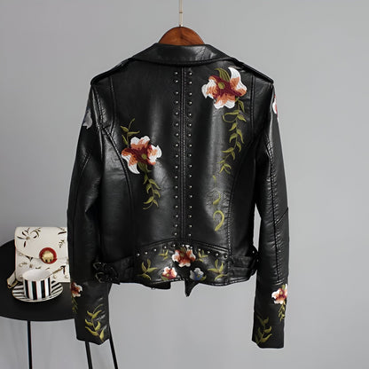 Stylish women's studded moto jacket featuring intricate floral embroidery on the back, perfect for edgy fashion.