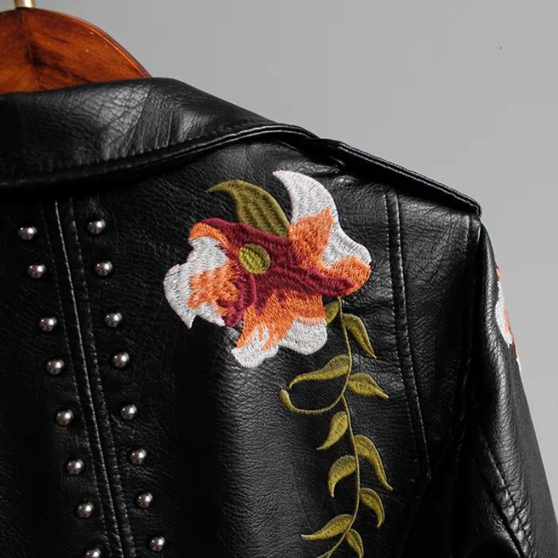 Edgy women's statement jacket: studded biker style with beautiful floral embroidery, a must-have outerwear piece.