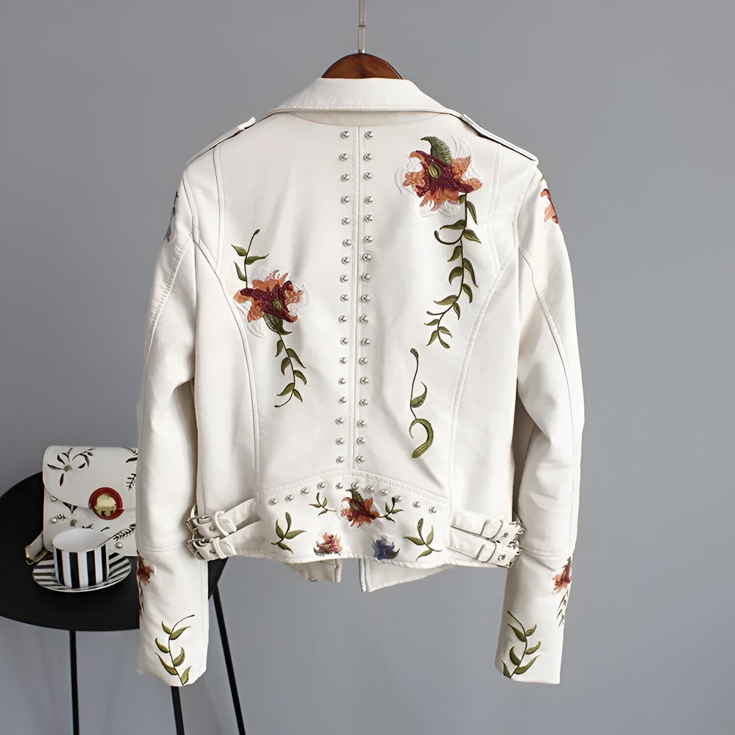 Women's trendy biker jacket, combining rebellious studs with delicate floral embroidery for a unique look.