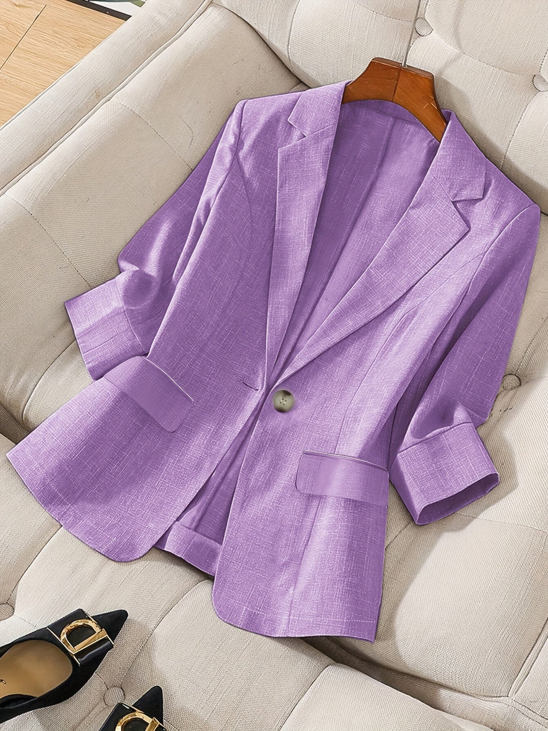 Women's black tailored cropped blazer. Modern business casual jacket with three-quarter sleeves for office wear.