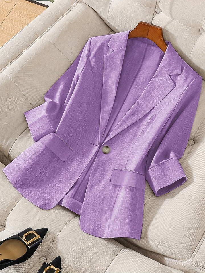 Women's black tailored cropped blazer. Modern business casual jacket with three-quarter sleeves for office wear.