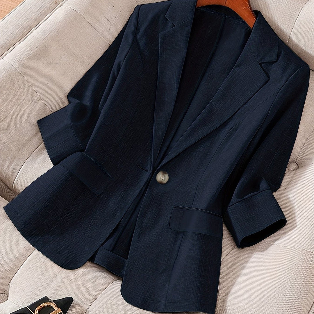 Three-quarter sleeve cropped blazer for women. Tailored fit, versatile fashion jacket for elegant office wear.