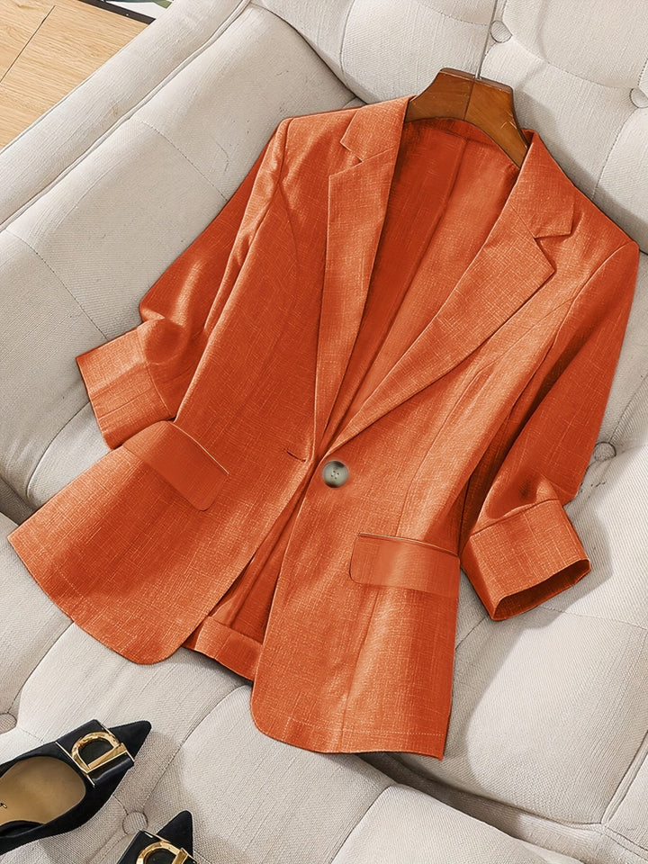 Stylish navy women's cropped blazer. Elegant tailored jacket, perfect for professional work attire & modern office.
