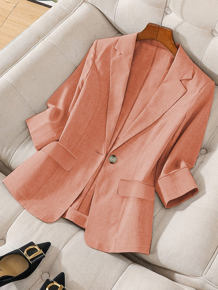 Women's professional cropped blazer. Tailored jacket in beige with three-quarter sleeves for modern office style.