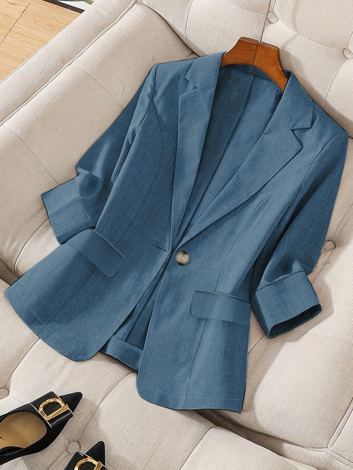 Sleek black women's cropped blazer. Tailored business casual jacket with 3/4 sleeves, a modern professional look.