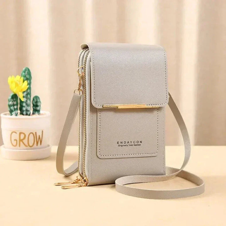 Compact women's hands-free crossbody purse, perfect for carrying essentials with integrated phone access.