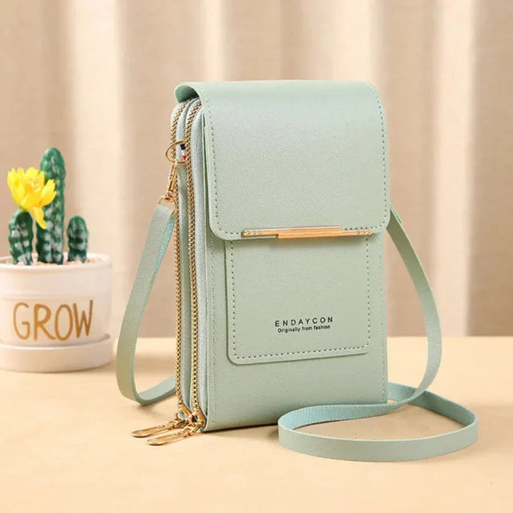 Organized women's phone crossbody bag with multiple compartments and a clear screen for quick phone use.