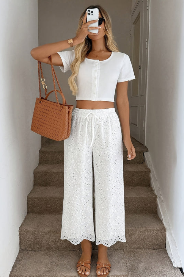 Relaxed fit women's cropped bohemian pants with eyelet details, ideal for summer vacation and travel.