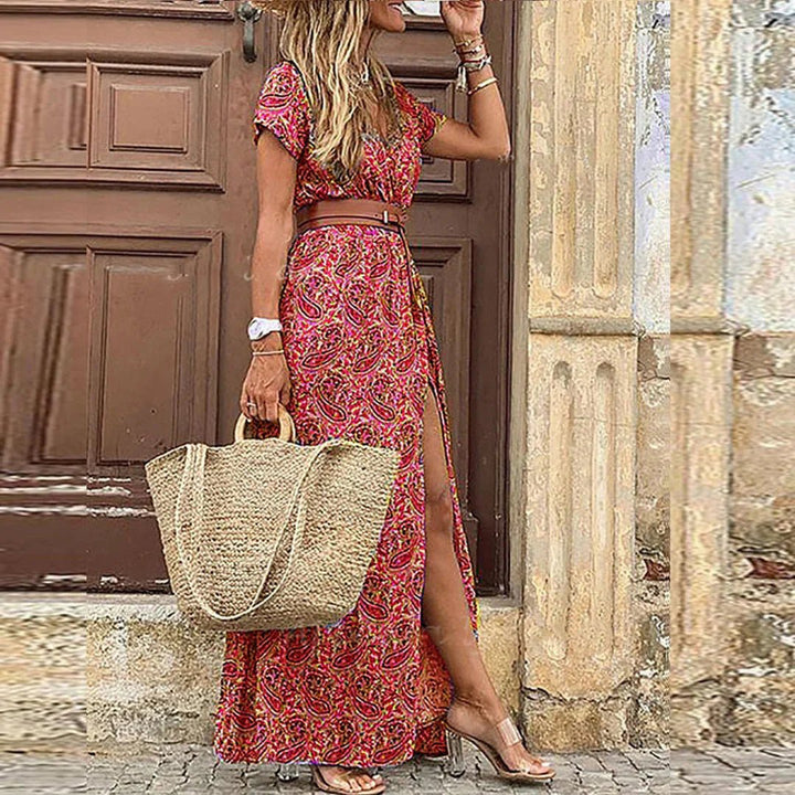Vibrant floral print Bohemian maxi dress for women, featuring a V-neck, sleeveless cut, and fashionable side slit.